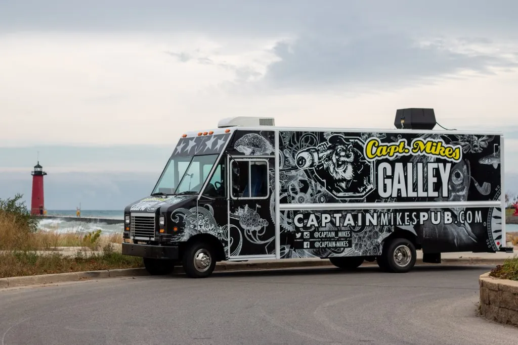 The Galley food truck on the Kenosha lakefront with the red pier lighthouse behind it